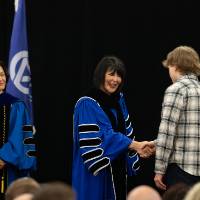 student receiving award and shaking hands with President